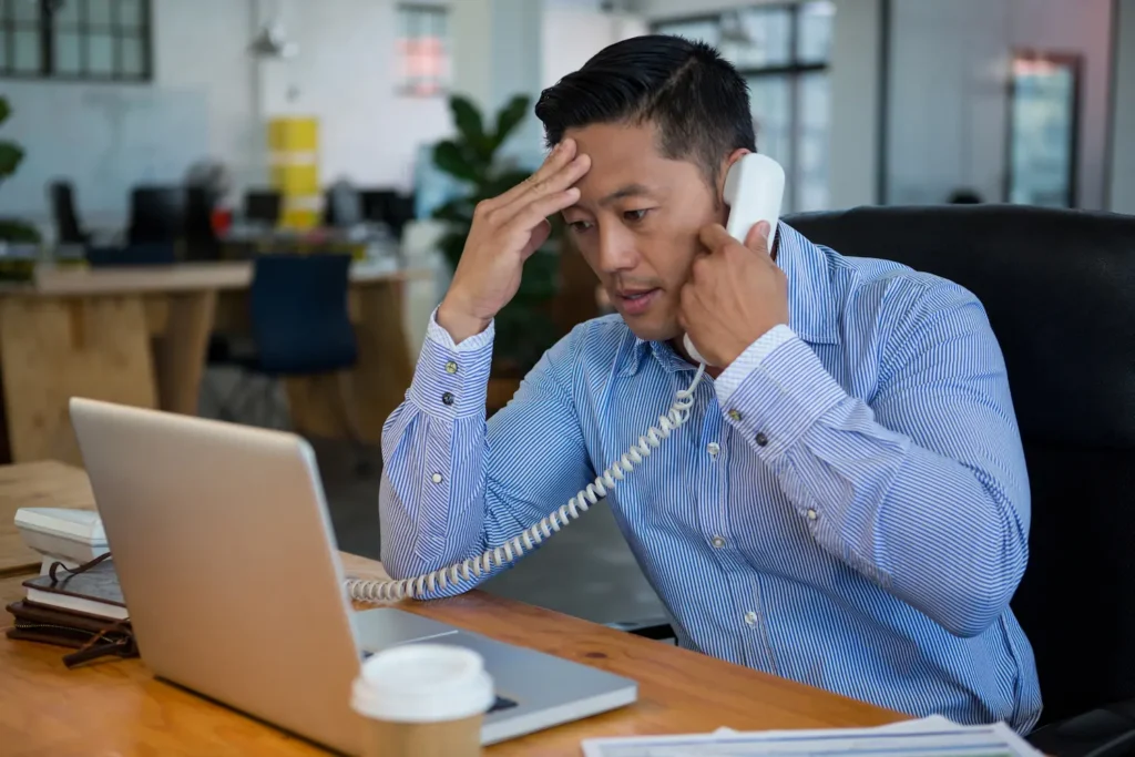 Frustrated business executive talking on outdated phone